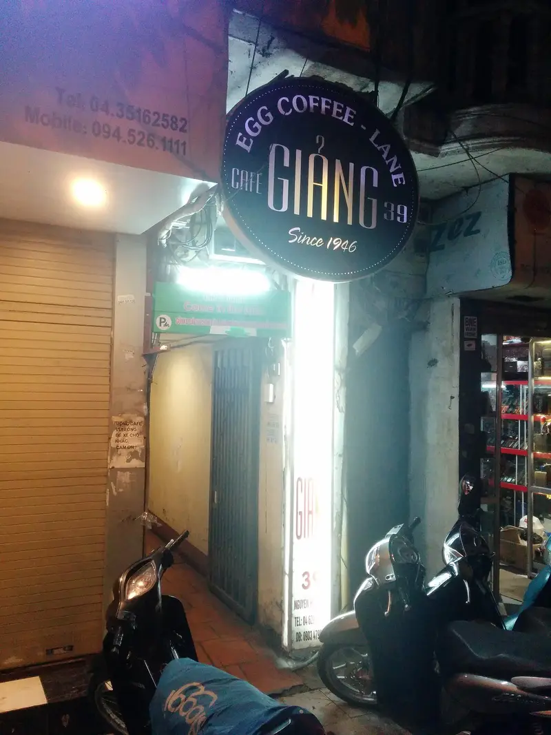 The lit sign of Café Giang in a Hanoi alley, home of egg coffee since 1946
